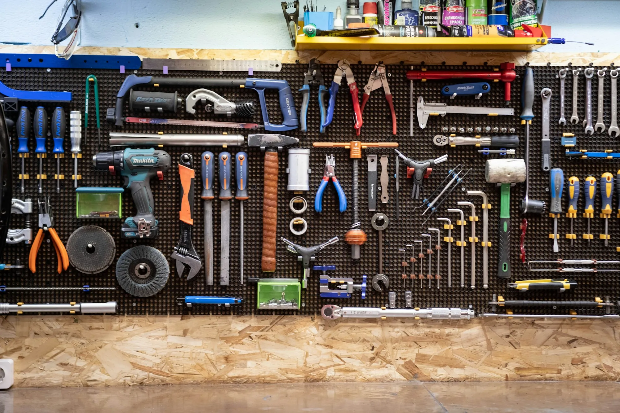 Workshop wall full of organized hand and power tools